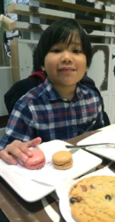 kid with macarons